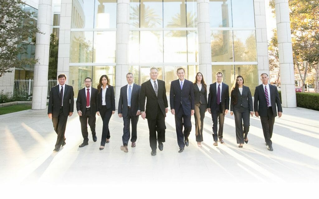 burn injury attorneys group photo 10 people in black suits yellow - Copy - Copy - Copy