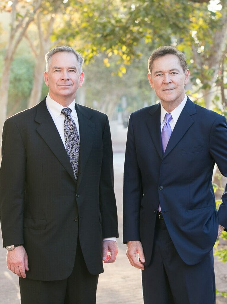 Derek Pakiz and Robert reeves standing outside in suits after winning a brain injury lawsuit