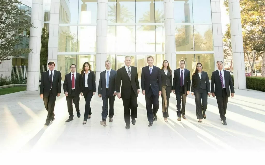 the reeves law group orange county attorney group walking towards camera in morning light outside